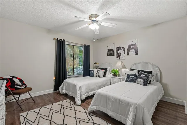 a bedroom with two beds and a chandelier