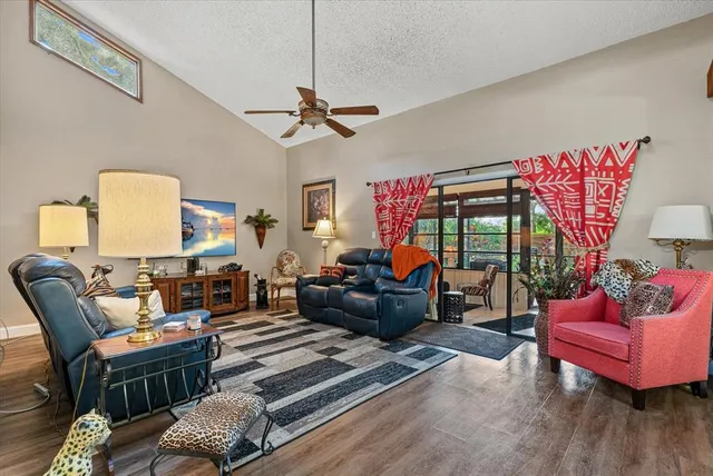 a living room with furniture a rug and a chandelier