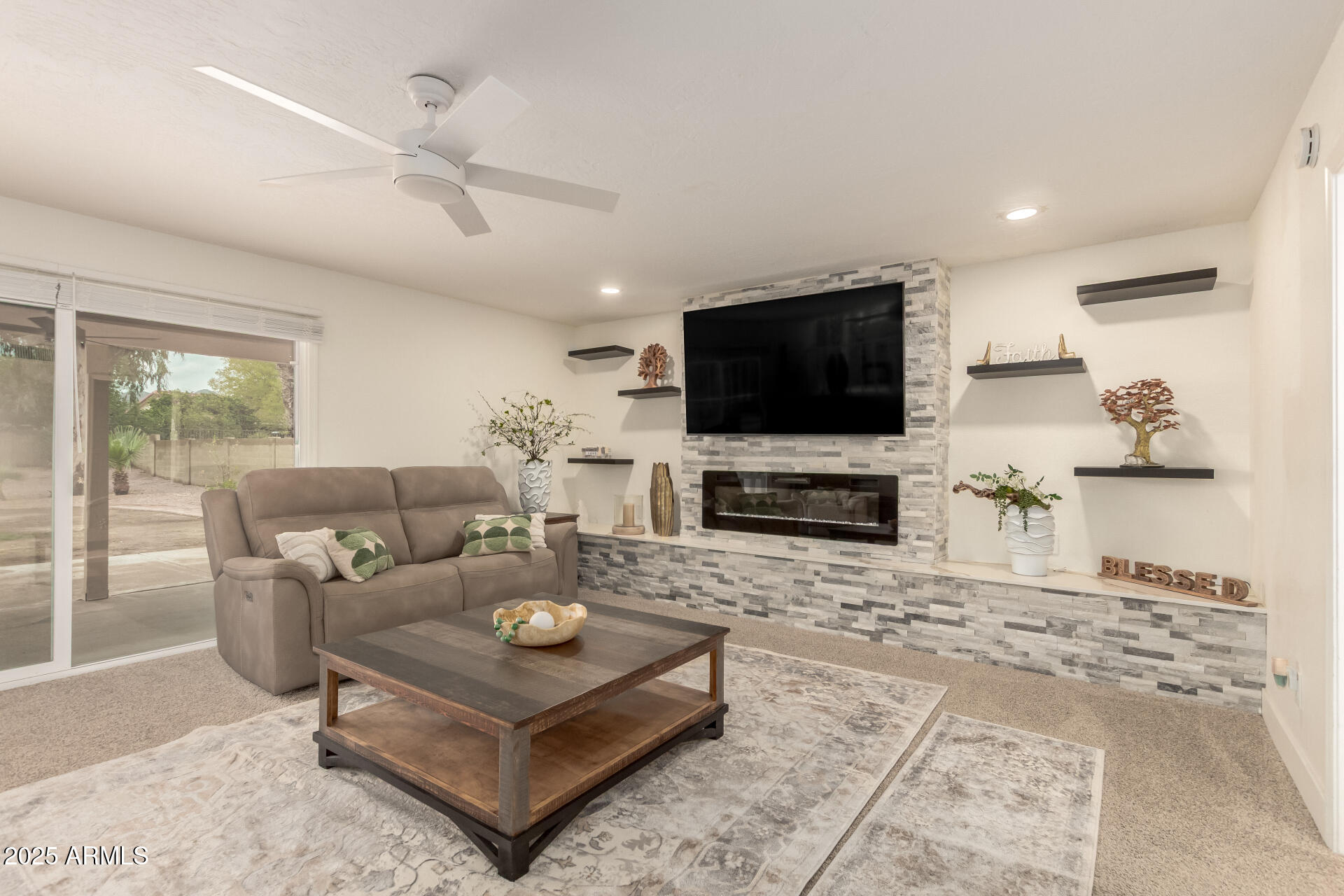 13042 South 42nd Street Phoenix, AZ 85044 - Photo 11 of 39 a living room with furniture a flat screen tv and a fireplace