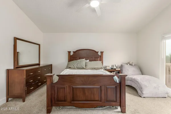 a bedroom with a bed and a dresser