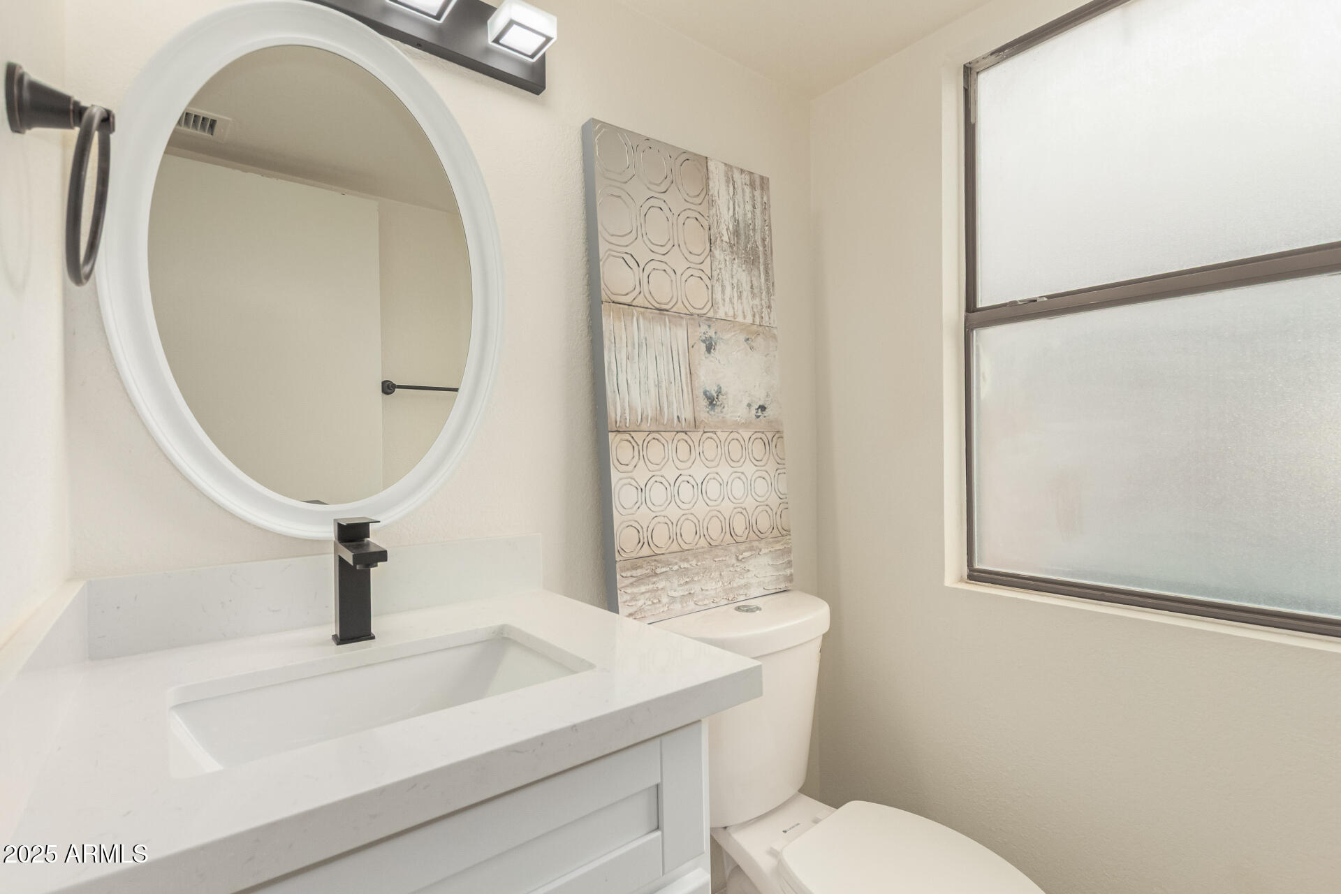 13042 South 42nd Street Phoenix, AZ 85044 - Photo 23 of 39 a bathroom with a sink toilet and a mirror