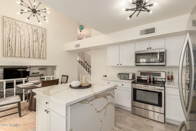 a kitchen with a stove a sink and a refrigerator