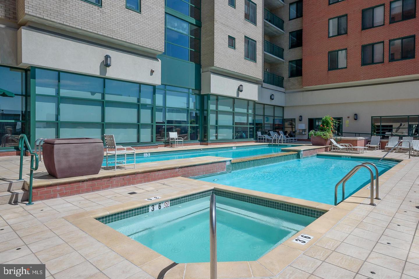 414 Water Street, Unit 2611 Baltimore, MD 21202 - Photo 17 of 23 a backyard of a house with barbeque oven table and chairs