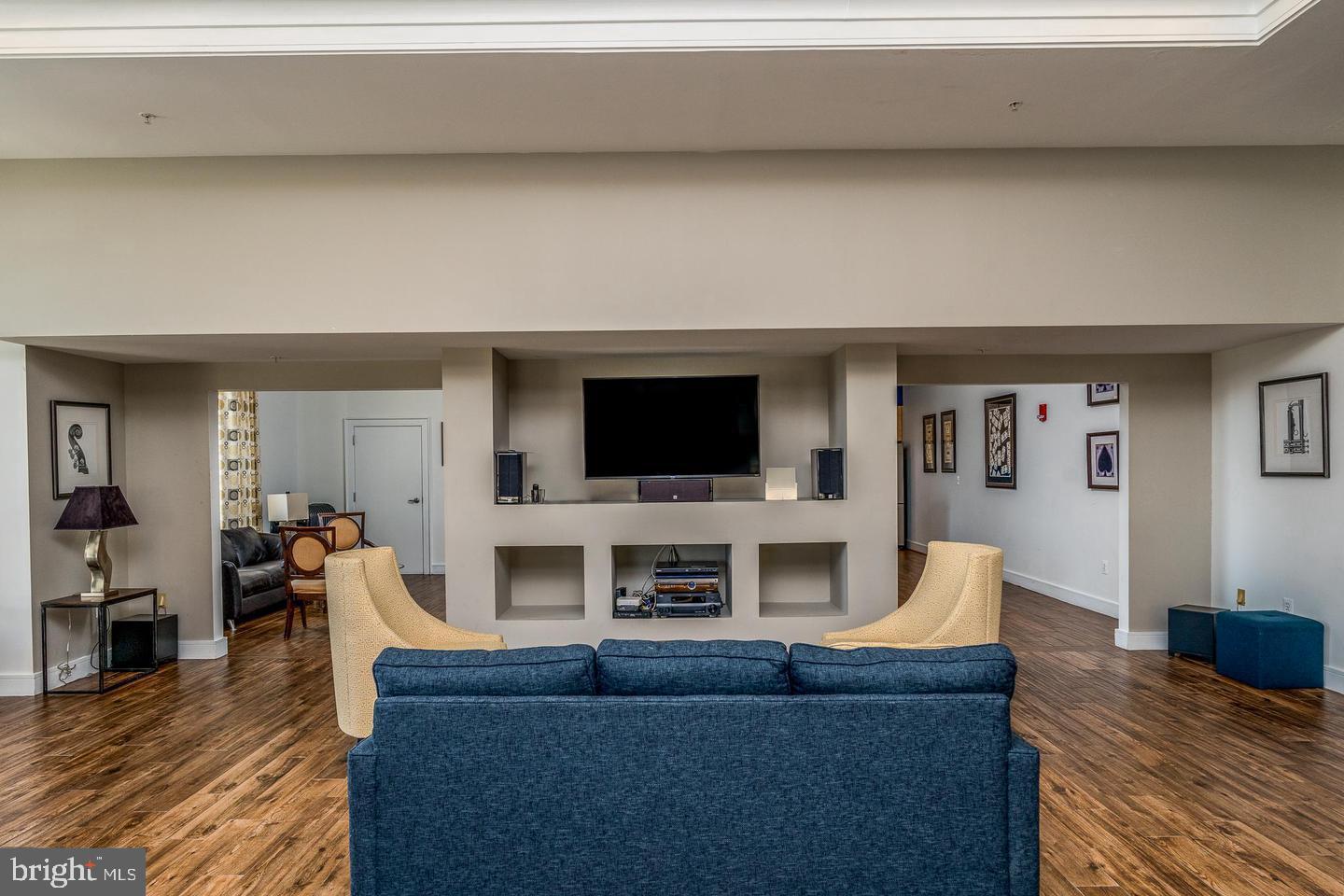 414 Water Street, Unit 2611 Baltimore, MD 21202 - Photo 19 of 23 a living room with furniture and a flat screen tv