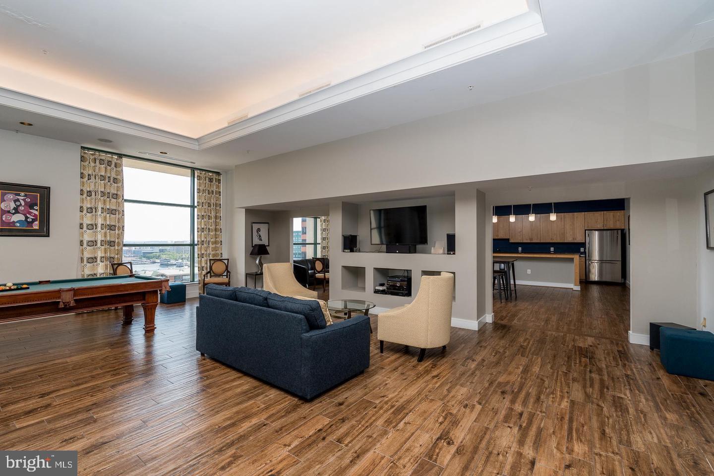 414 Water Street, Unit 2611 Baltimore, MD 21202 - Photo 20 of 23 a living room with furniture and a wooden floor