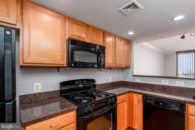 a kitchen with granite countertop a sink and cabinets