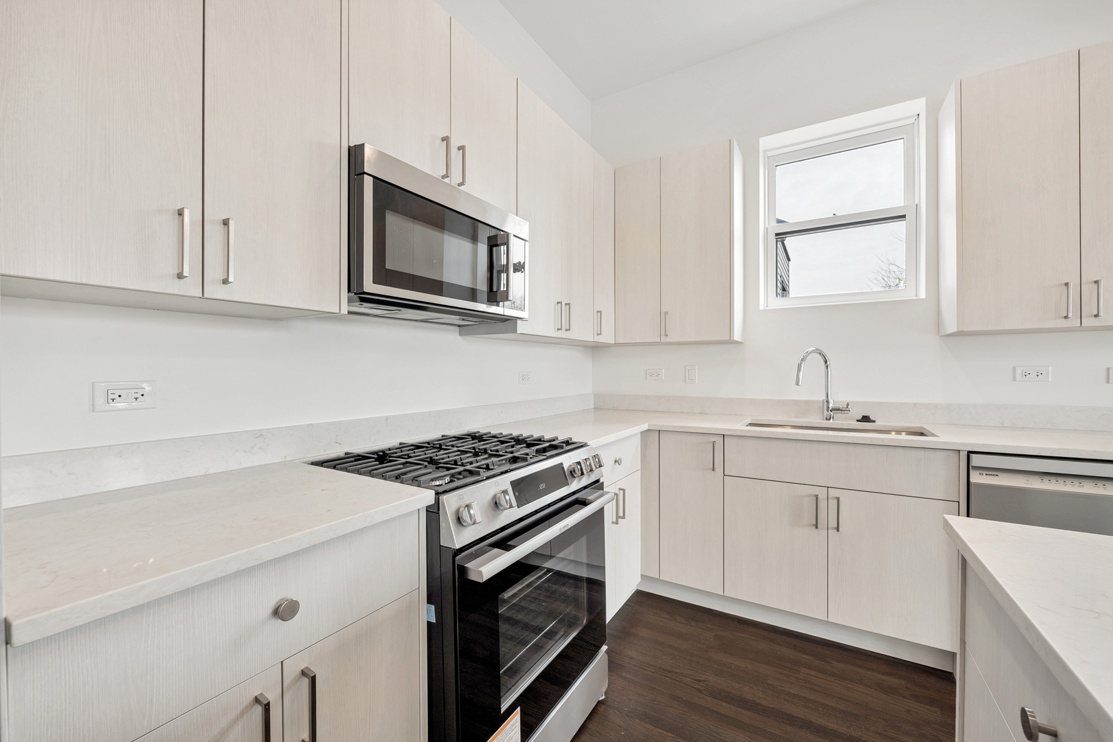 1952 West Ohio Street, Unit 3E Chicago, IL 60622 - Photo 12 of 27 a kitchen with stainless steel appliances granite countertop a sink stove a microwave and cabinets
