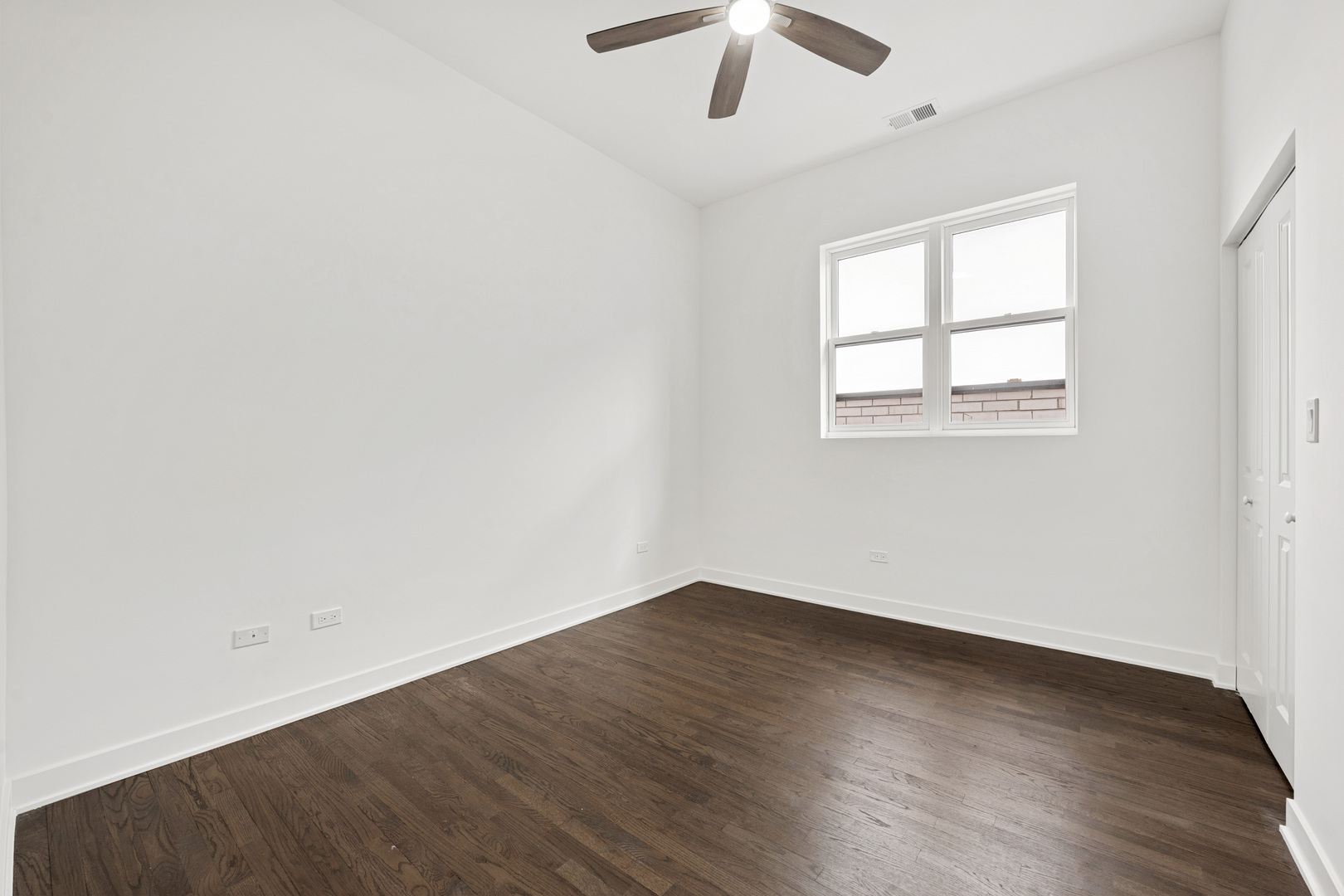 1952 West Ohio Street, Unit 3E Chicago, IL 60622 - Photo 21 of 27 an empty room with wooden floor chandelier fan and windows