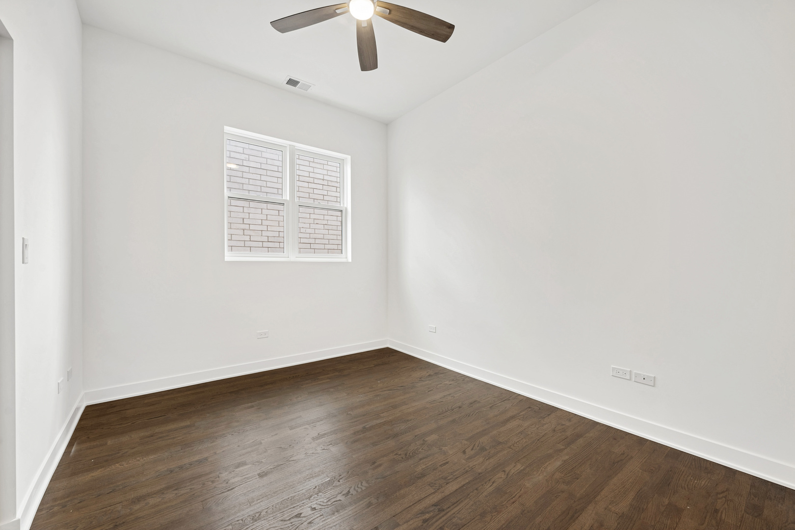 1952 West Ohio Street, Unit 3E Chicago, IL 60622 - Photo 23 of 27 an empty room with wooden floor fan and windows