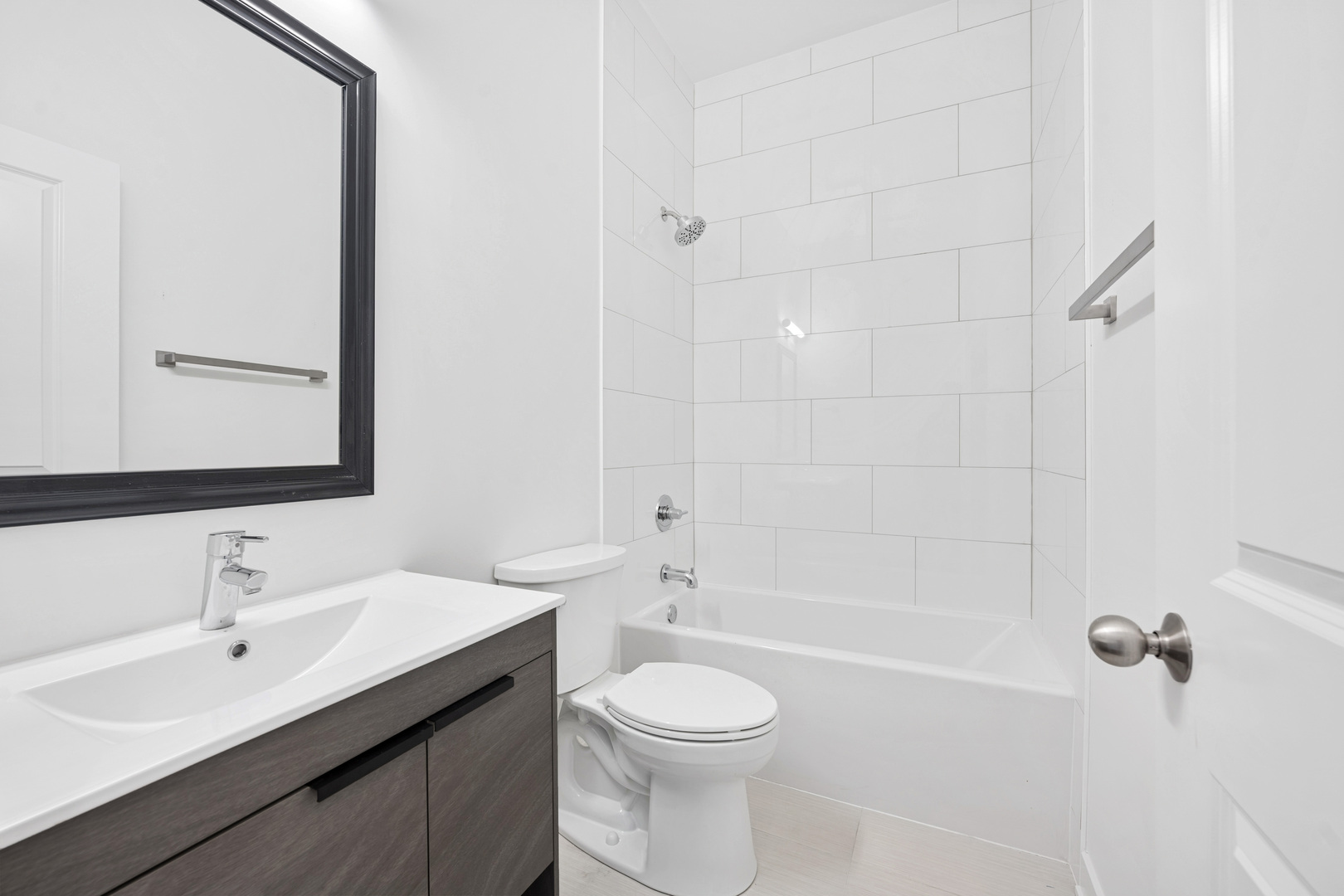1952 West Ohio Street, Unit 3E Chicago, IL 60622 - Photo 24 of 27 a bathroom with a toilet a sink a mirror and shower