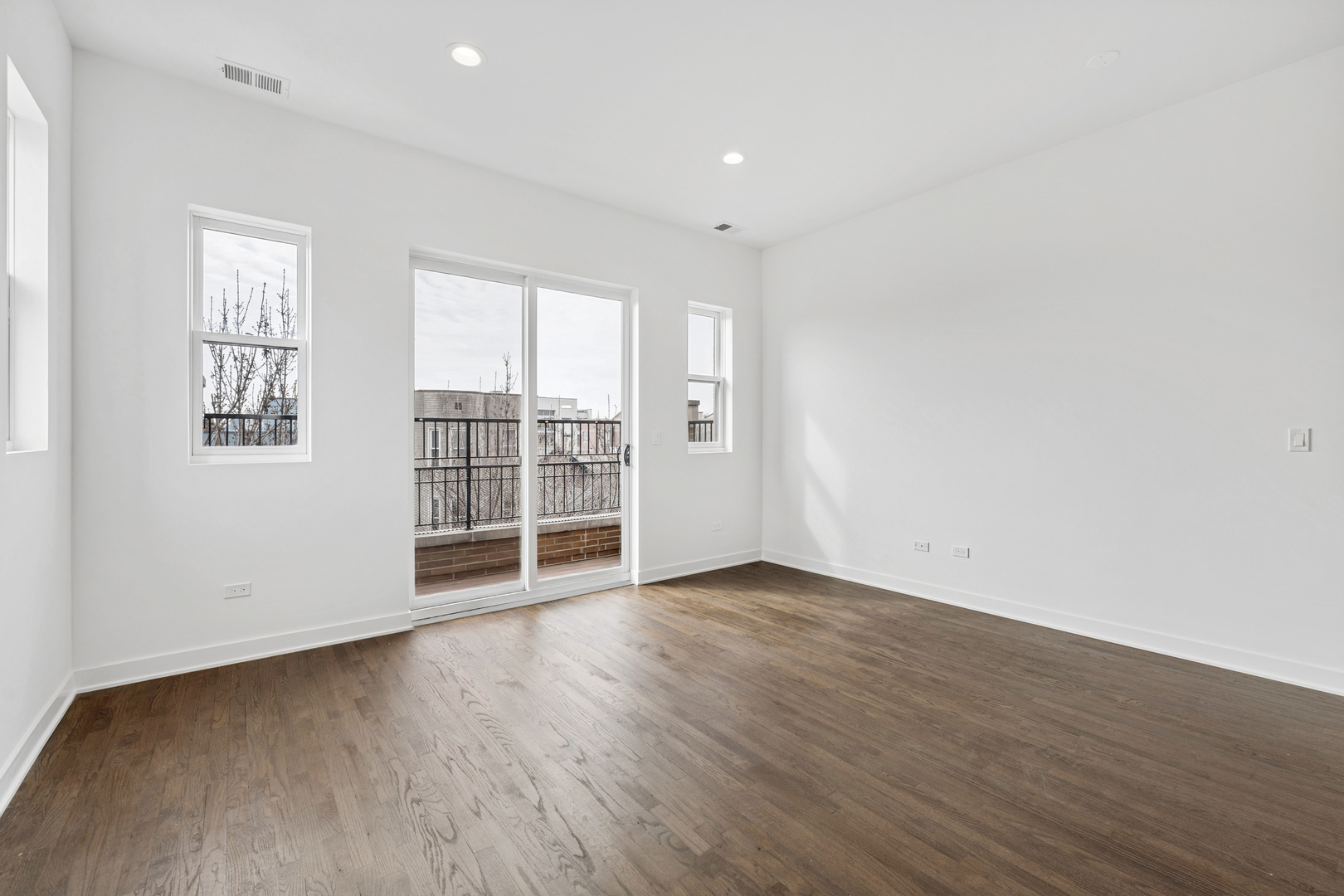 1952 West Ohio Street, Unit 3E Chicago, IL 60622 - Photo 4 of 27 an empty room with wooden floor and windows