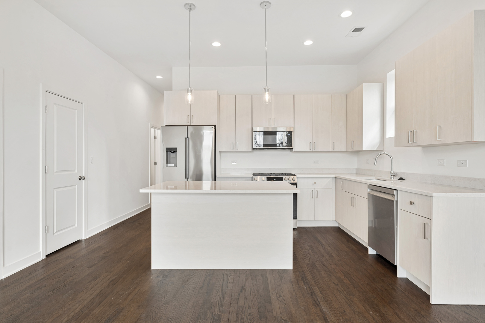 1952 West Ohio Street, Unit 3E Chicago, IL 60622 - Photo 8 of 27 a kitchen with kitchen island white cabinets and white appliances