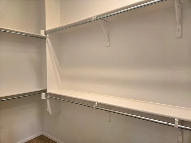 a view of a yard in front of a house with large trees