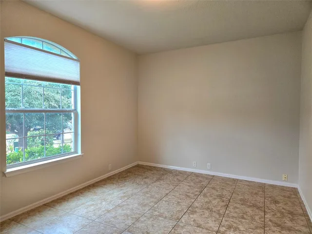 a bathroom with a granite countertop sink toilet a mirror a bathtub and shower