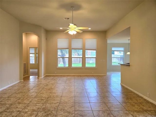 an empty room with fireplace and wooden floor