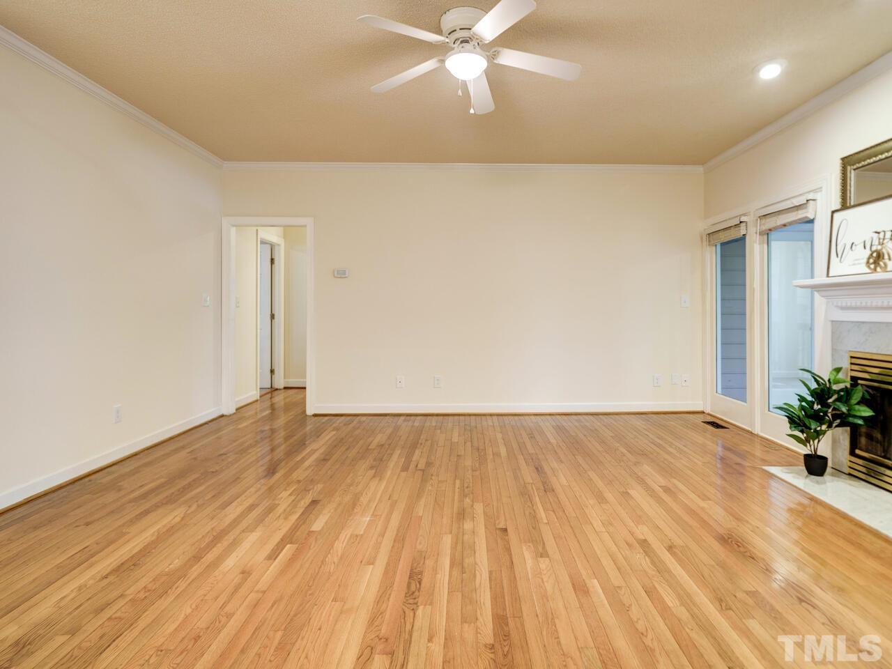 4121 Starboard Court Raleigh, NC 27613 - Photo 11 of 45 an empty room with wooden floor and windows