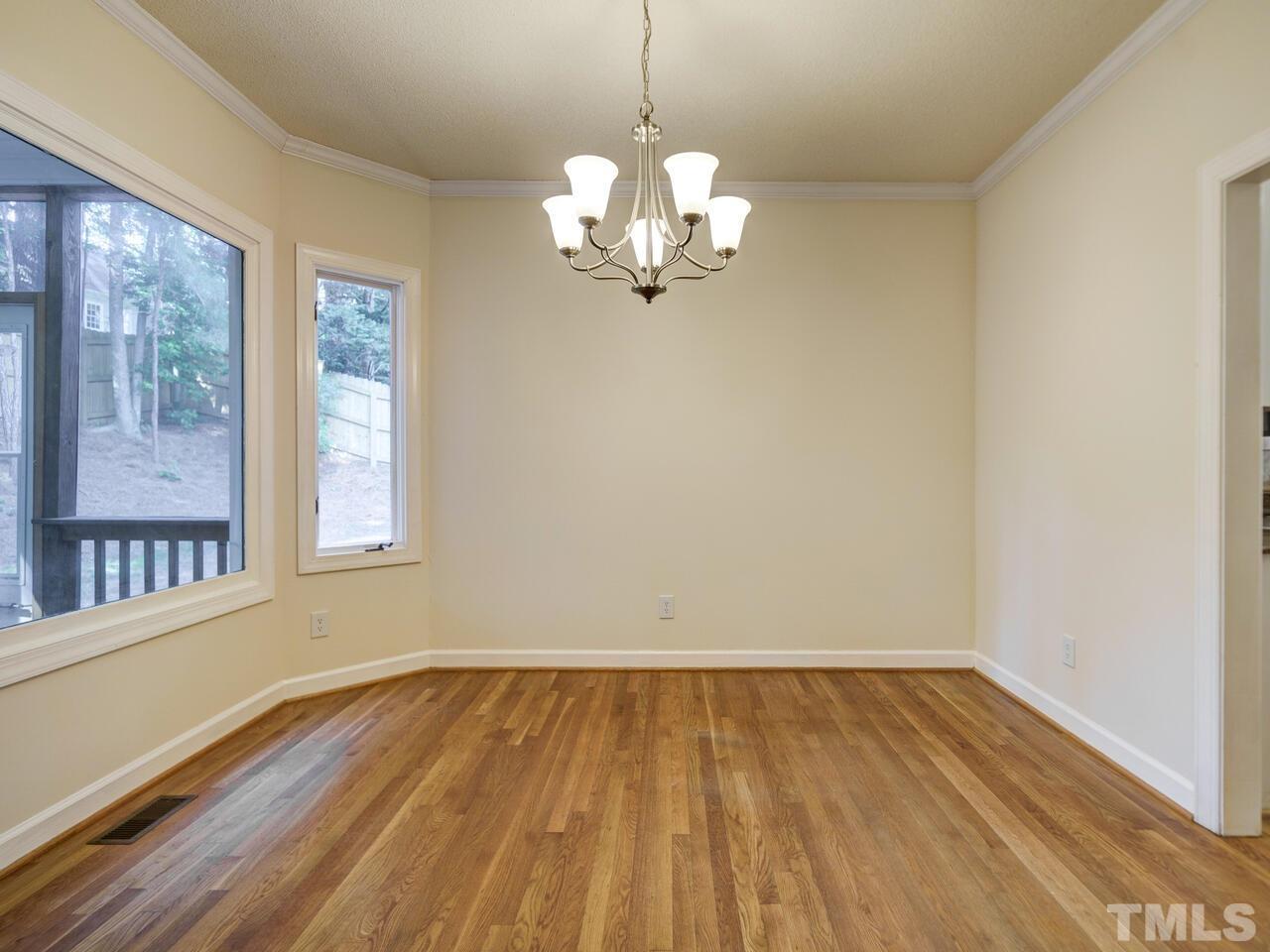4121 Starboard Court Raleigh, NC 27613 - Photo 14 of 45 a view of a room with wooden floor and large windows