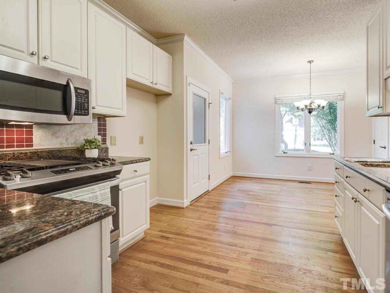 4121 Starboard Court Raleigh, NC 27613 - Photo 18 of 45 a kitchen with stainless steel appliances granite countertop a stove and a sink