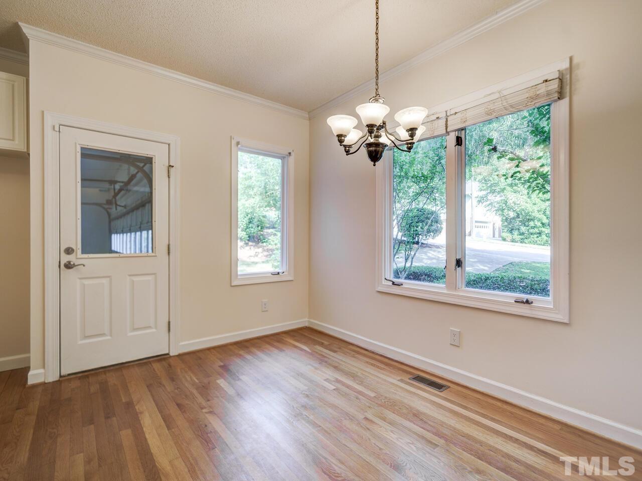 4121 Starboard Court Raleigh, NC 27613 - Photo 22 of 45 a view of an empty room with a window and wooden floor