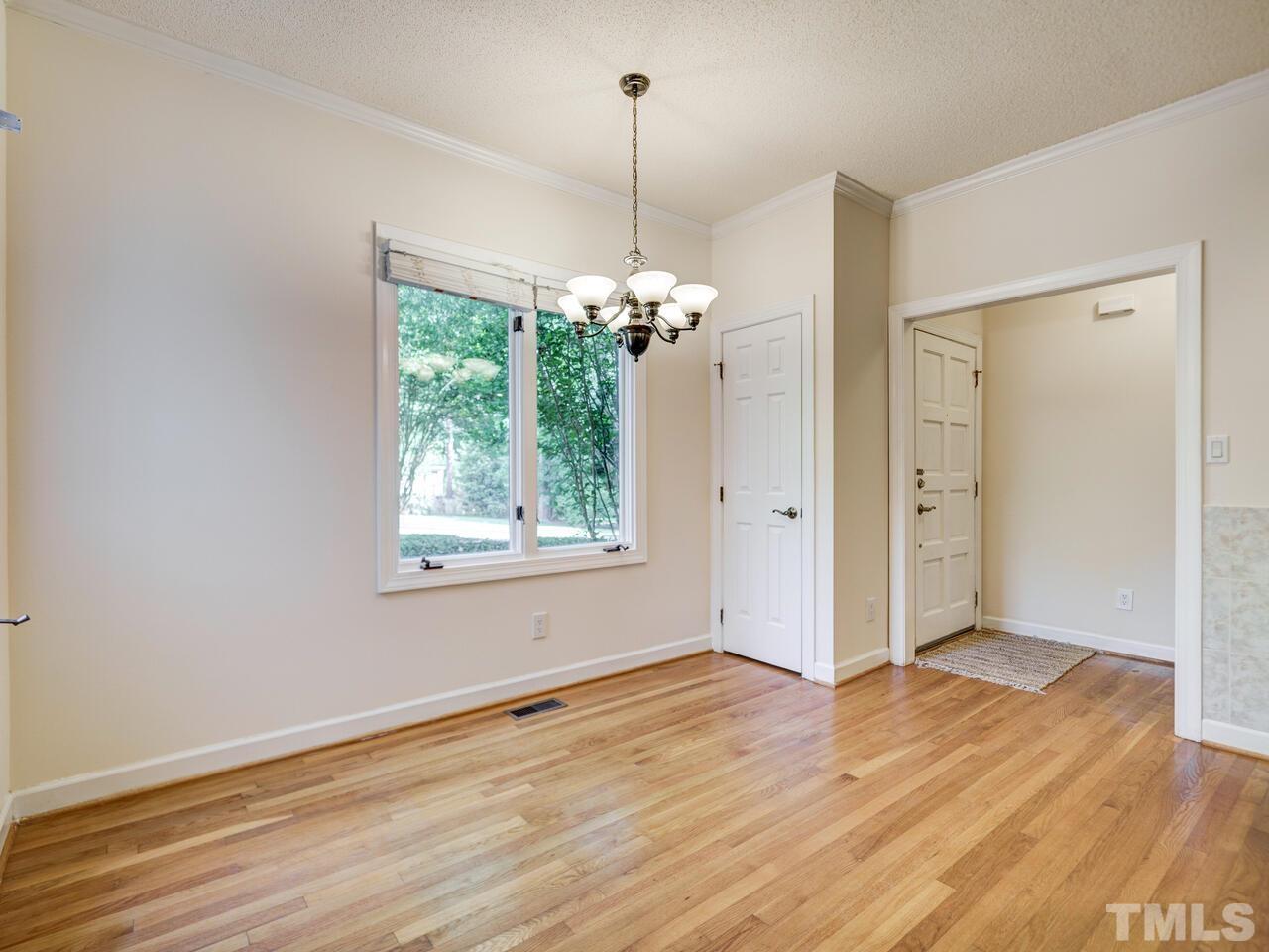 4121 Starboard Court Raleigh, NC 27613 - Photo 23 of 45 a view of a room with wooden floor chandelier and window