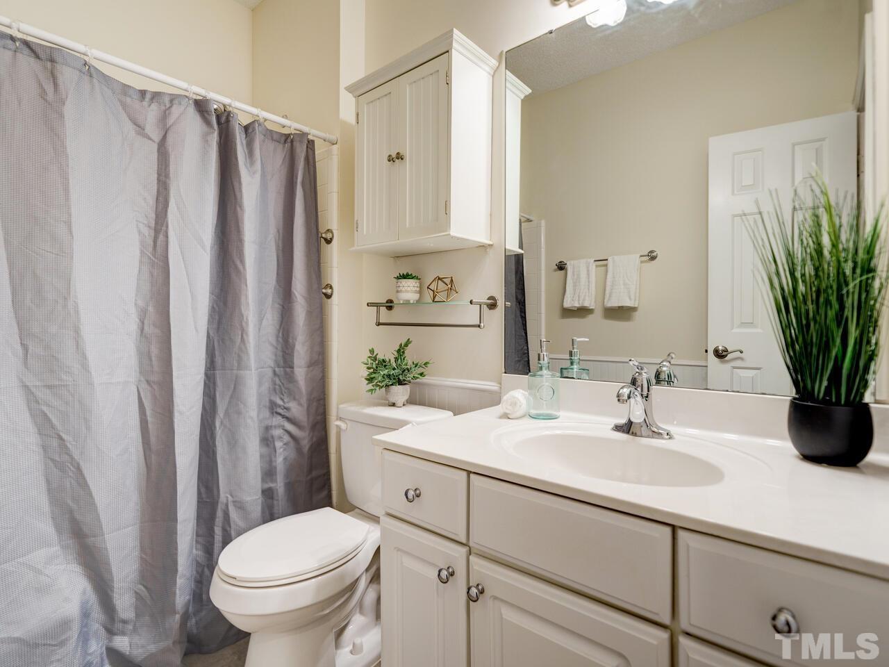 4121 Starboard Court Raleigh, NC 27613 - Photo 26 of 45 a bathroom with a sink toilet and shower