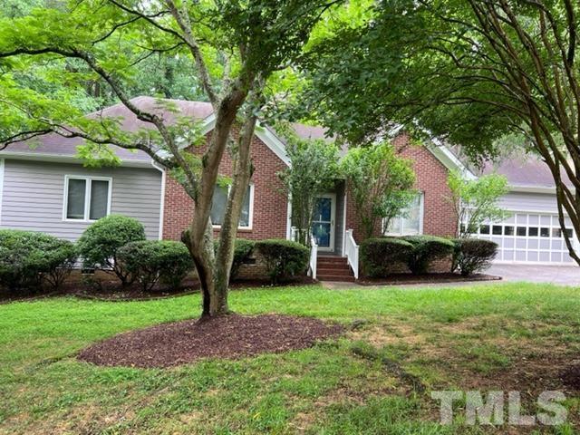 4121 Starboard Court Raleigh, NC 27613 - Photo 3 of 45 a front view of a house with garden and trees