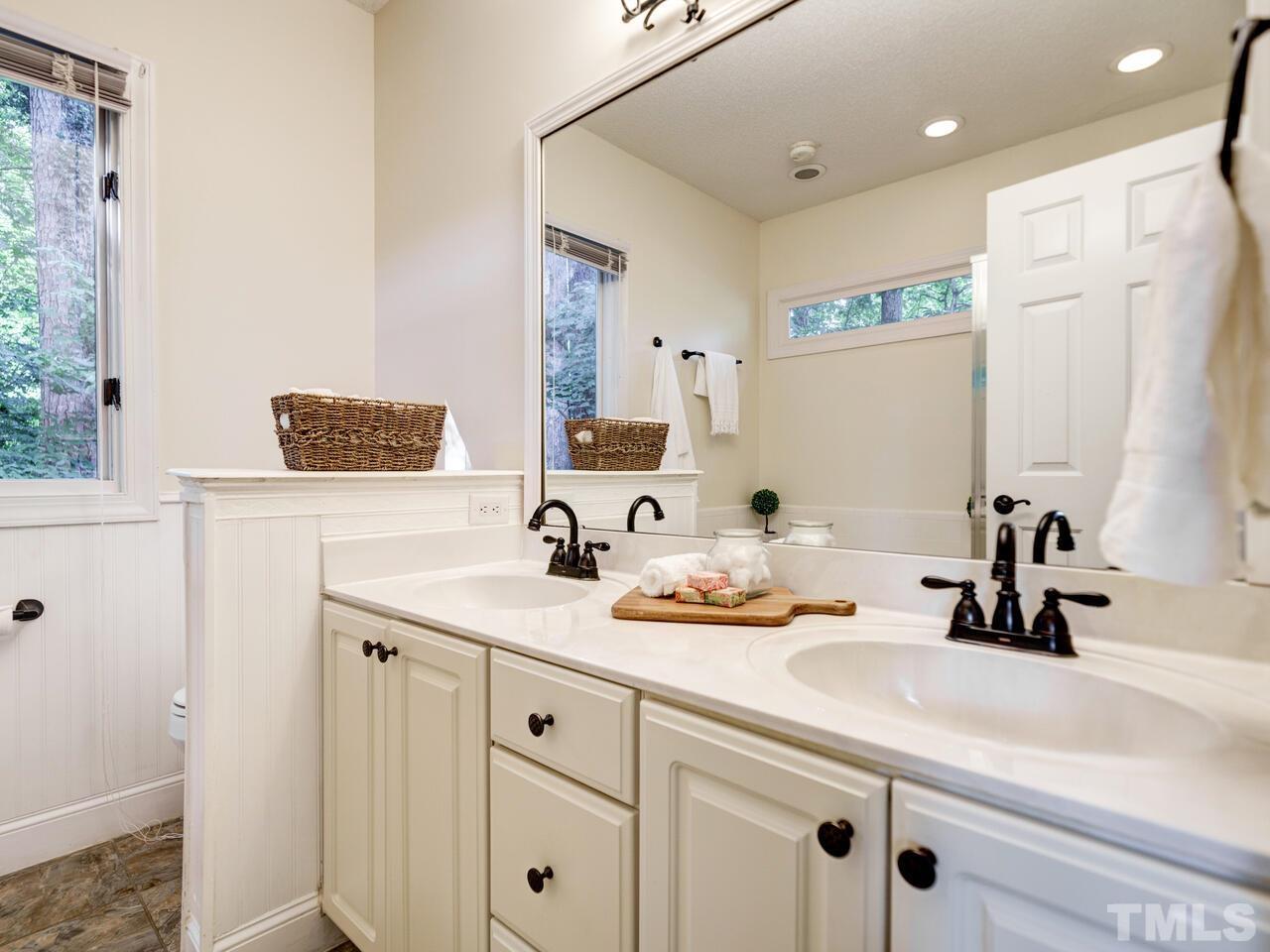 4121 Starboard Court Raleigh, NC 27613 - Photo 34 of 45 a bathroom with a sink and a mirror