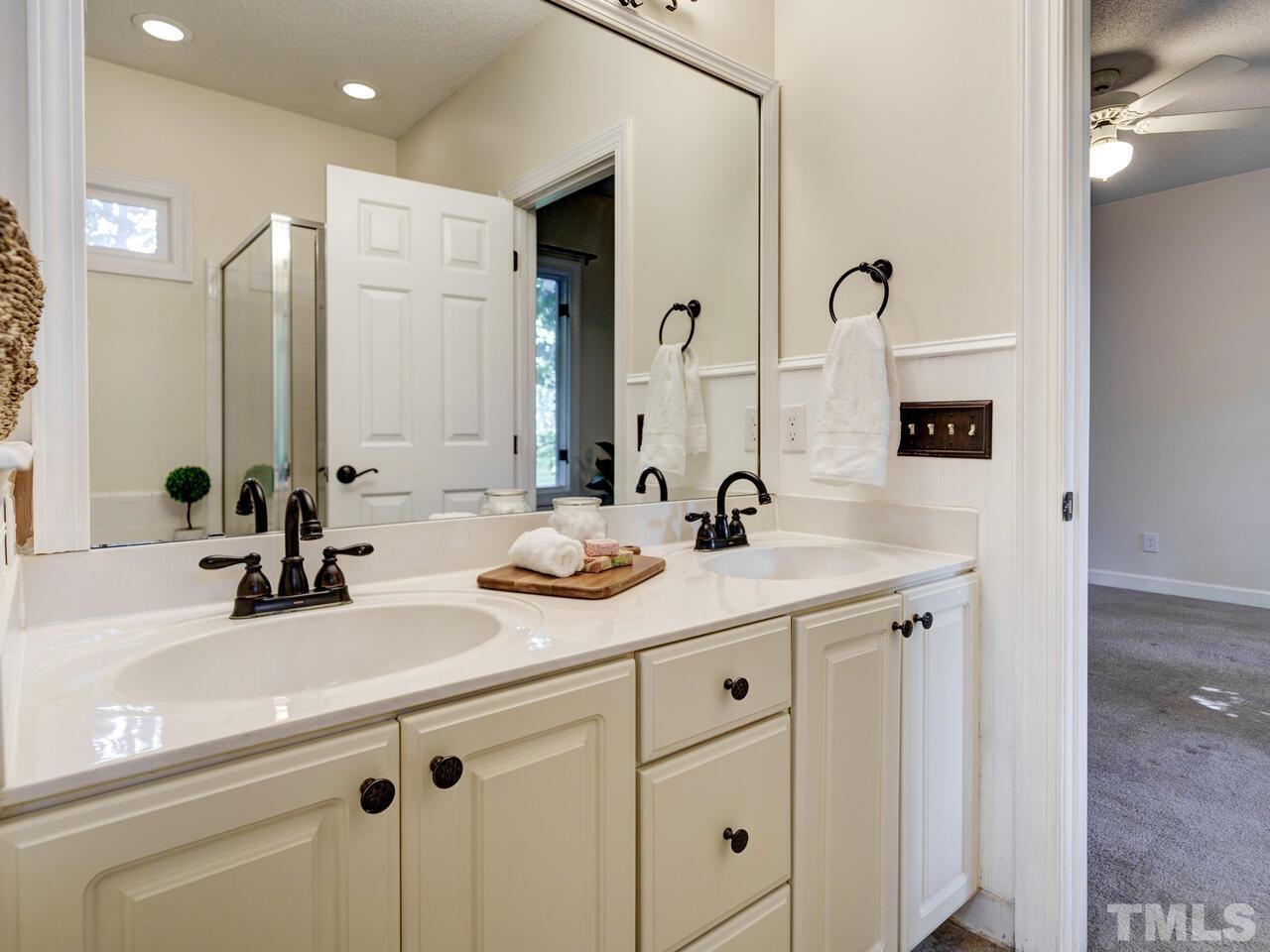 4121 Starboard Court Raleigh, NC 27613 - Photo 35 of 45 a bathroom with a sink and a mirror