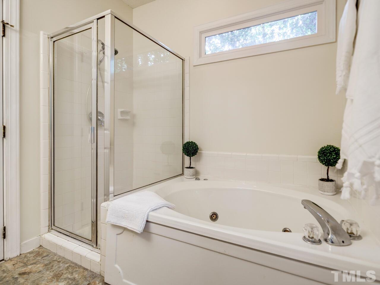 4121 Starboard Court Raleigh, NC 27613 - Photo 36 of 45 a bathroom with a tub and a shower