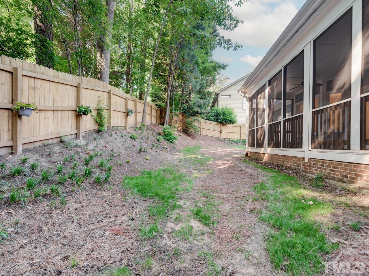 4121 Starboard Court Raleigh, NC 27613 - Photo 45 of 45 a view of an house with backyard and trees