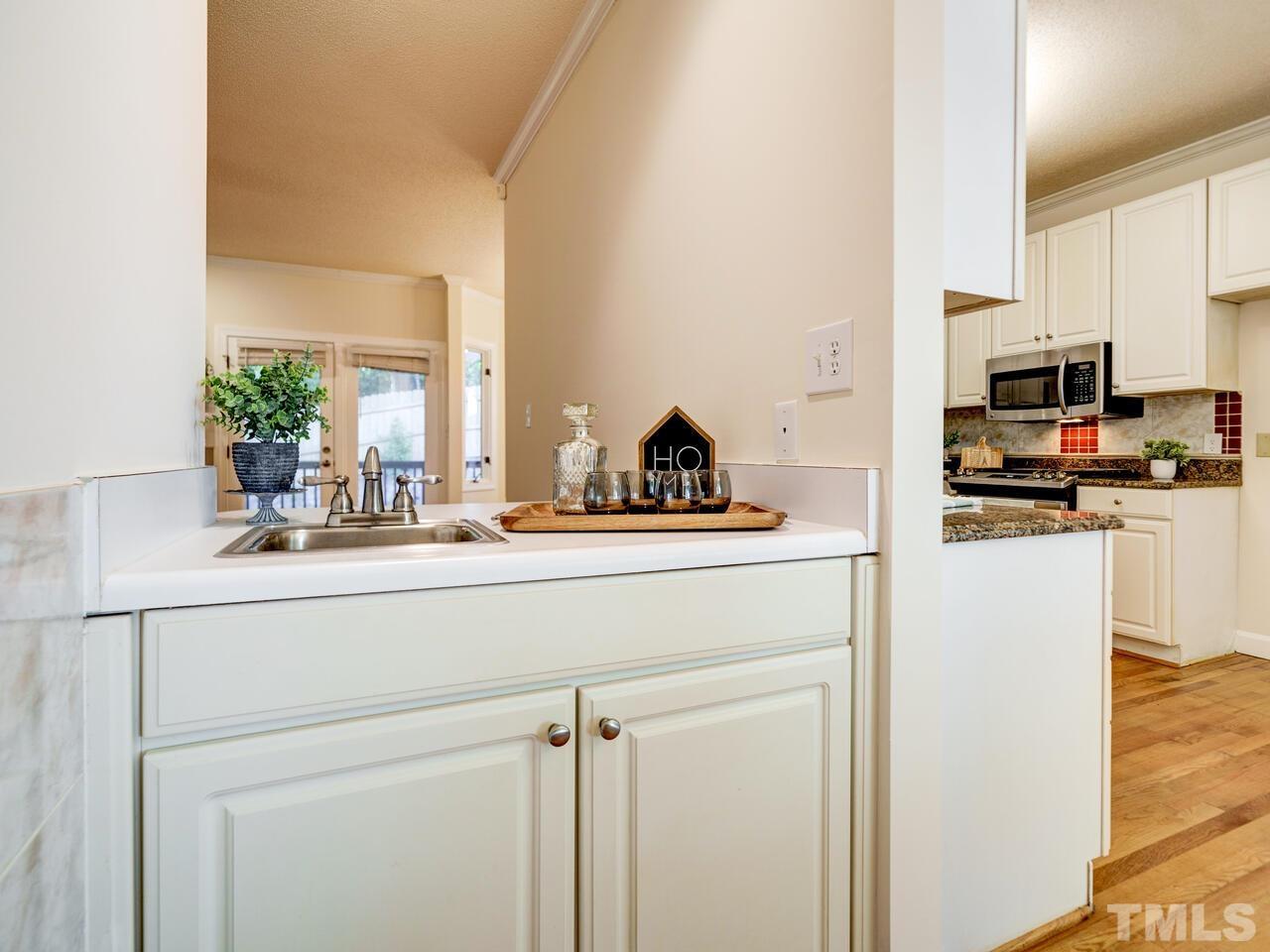 4121 Starboard Court Raleigh, NC 27613 - Photo 6 of 45 a kitchen with appliances a sink and cabinets