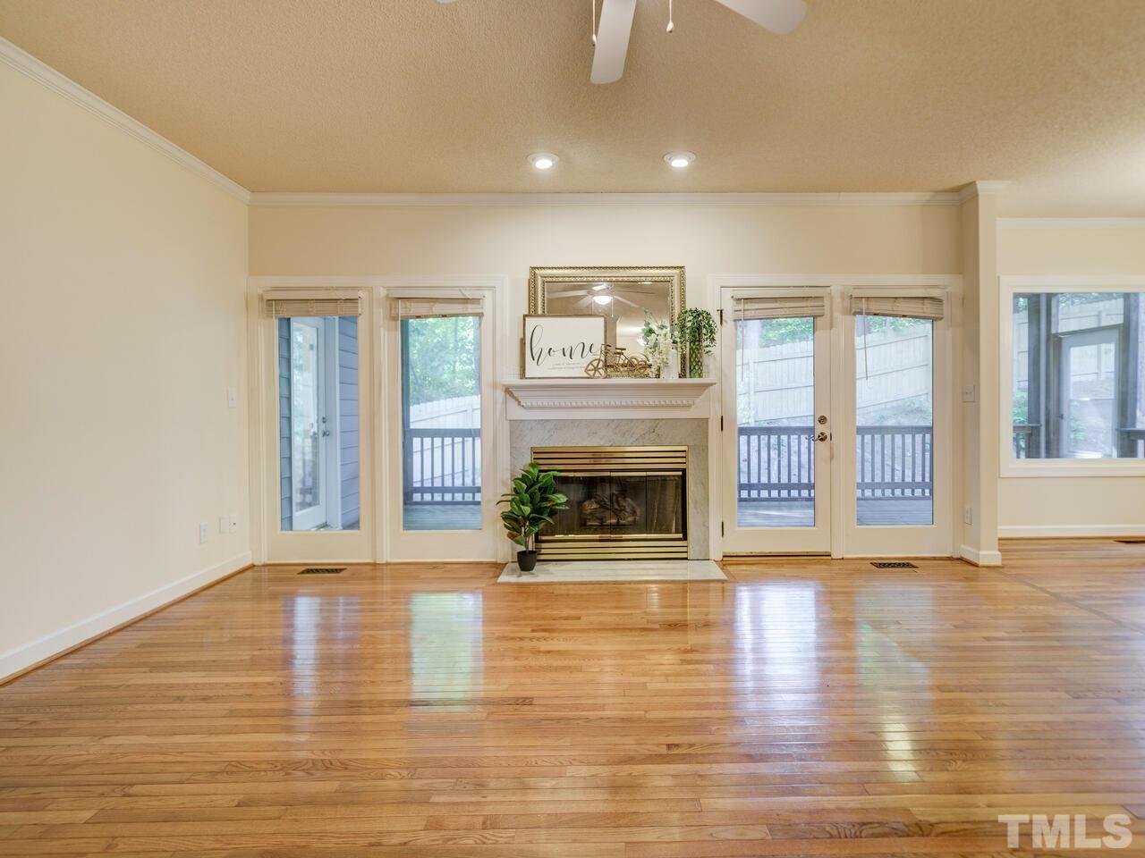 4121 Starboard Court Raleigh, NC 27613 - Photo 7 of 45 a view of a livingroom with fireplace wooden floor and windows