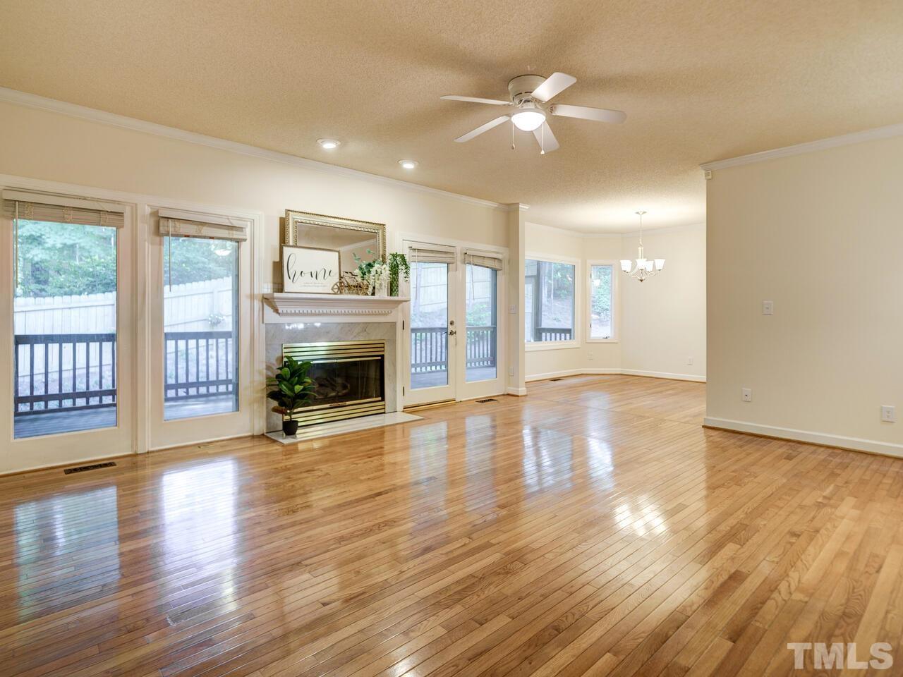 4121 Starboard Court Raleigh, NC 27613 - Photo 8 of 45 wooden floor fireplace and windows in an empty room