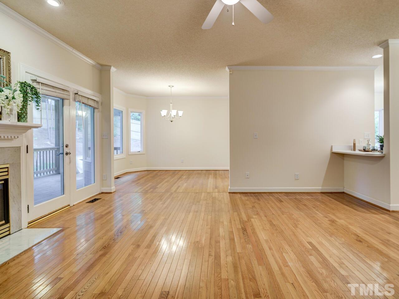4121 Starboard Court Raleigh, NC 27613 - Photo 9 of 45 an empty room with wooden floor and a fireplace