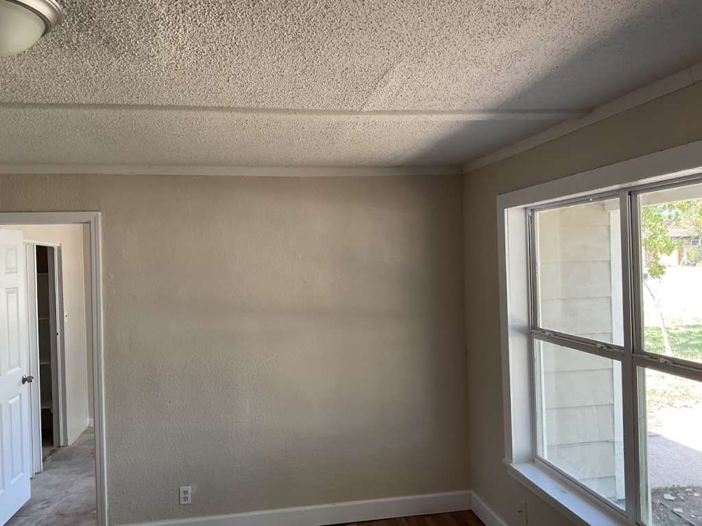 815 West 12th Street Freeport, TX 77541 - Photo 4 of 9 a view of a small space with wooden floor and a window
