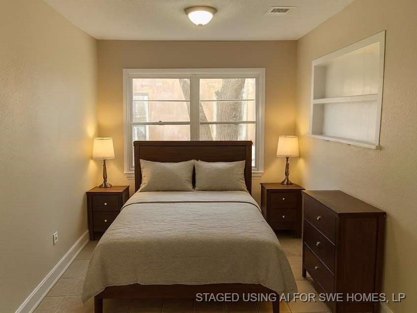 815 West 12th Street Freeport, TX 77541 - Photo 8 of 11 a bedroom with a bed and a window