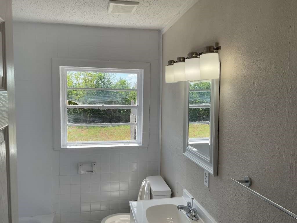 815 West 12th Street Freeport, TX 77541 - Photo 10 of 11 a bathroom with a sink and a mirror