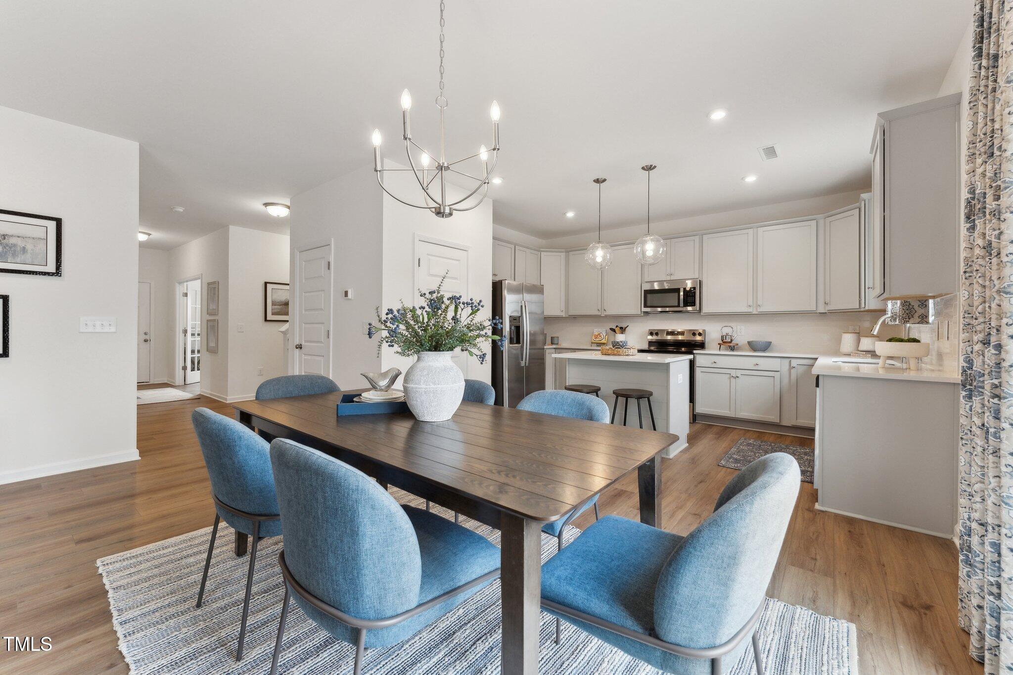 27 Cribbs Lane Middlesex, NC 27557 - Photo 6 of 41 a kitchen with a dining table chairs wooden floor appliances and cabinets