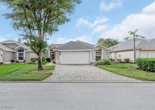 a front view of a house with a yard and garage