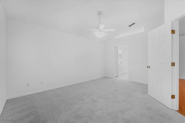 a view of empty room with ceiling fan