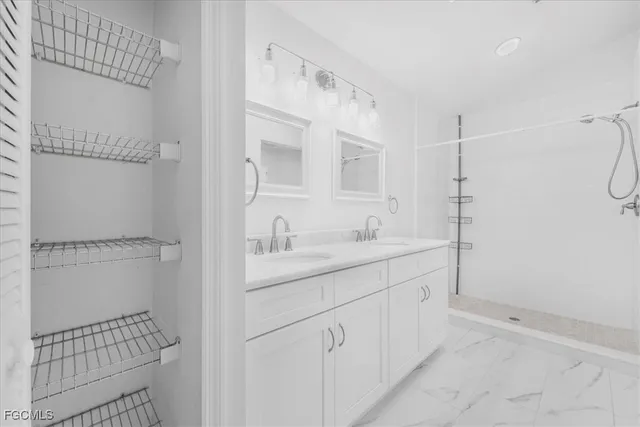 a bathroom with a shower sink and mirror