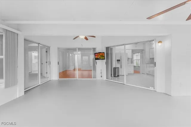 a view of an empty room with windows