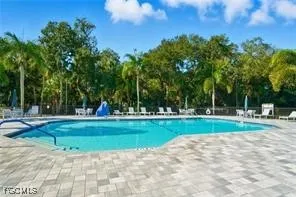 an aerial view of residential houses with outdoor space and swimming pool