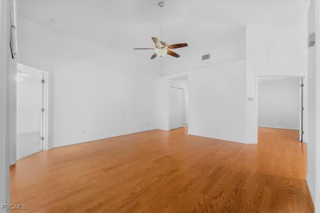 a view of a big room with wooden floor and windows in a room
