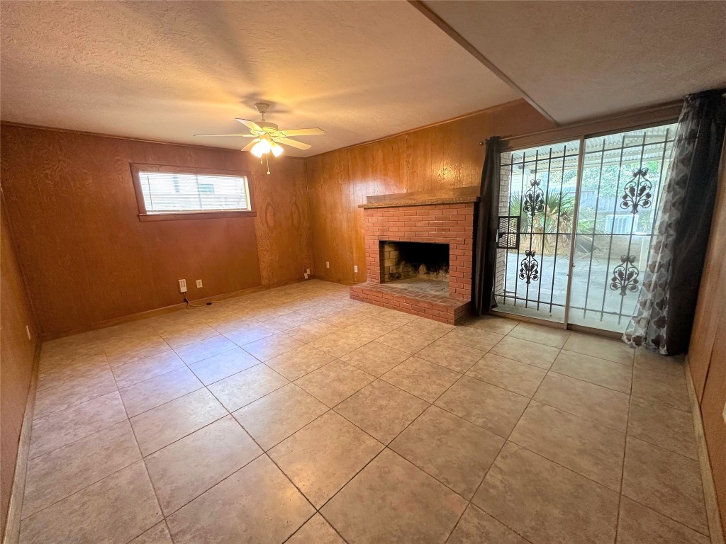 903 Lamonte Lane Houston, TX 77018 - Photo 15 of 36 a view of an empty room with a fireplace and a window