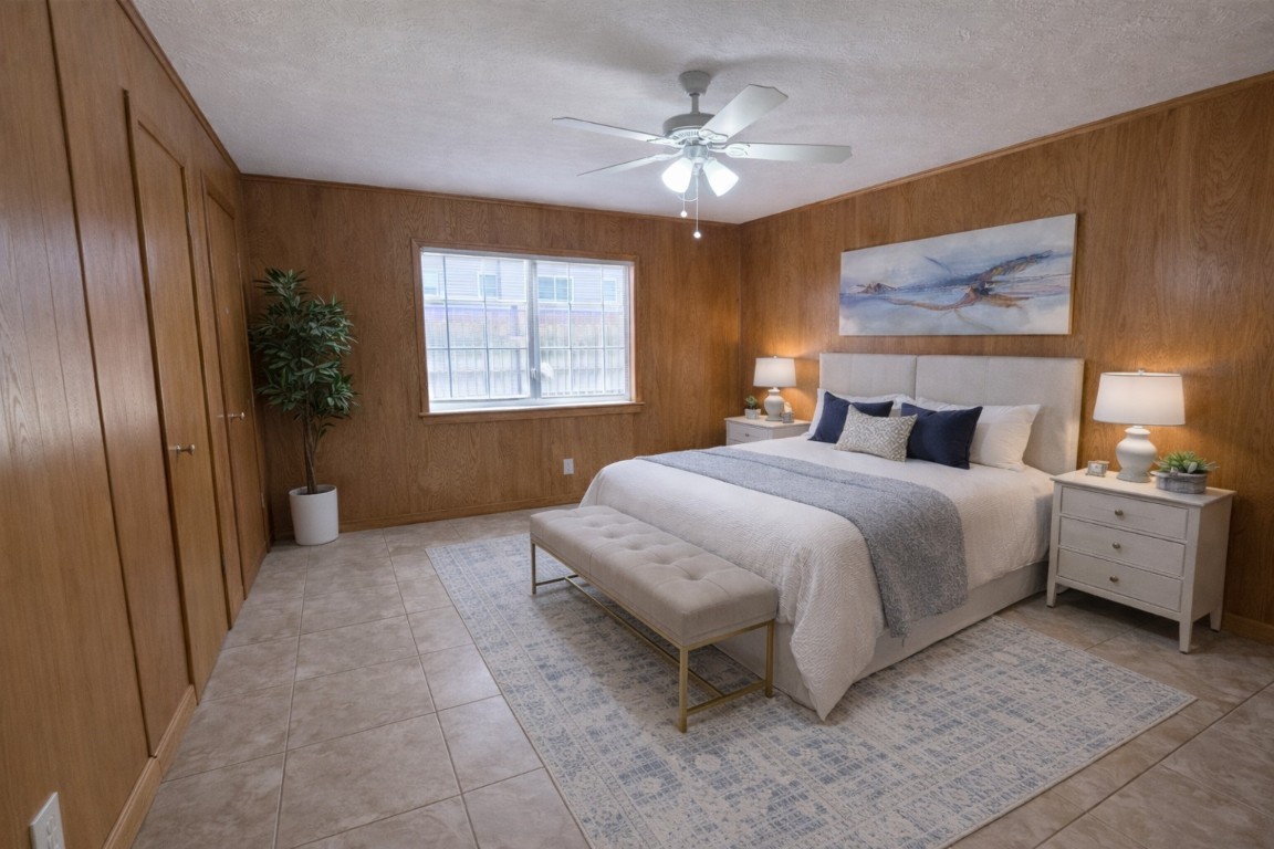 903 Lamonte Lane Houston, TX 77018 - Photo 19 of 36 a spacious bedroom with a bed and a chandelier