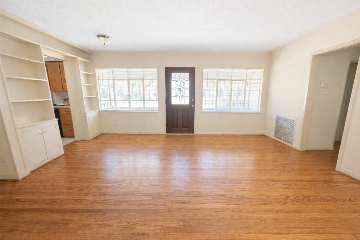 903 Lamonte Lane Houston, TX 77018 - Photo 3 of 36 an empty room with wooden floor and windows