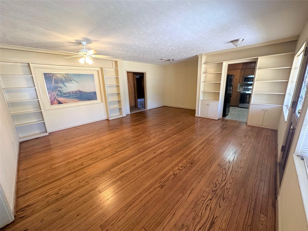 903 Lamonte Lane Houston, TX 77018 - Photo 4 of 36 a view of an empty room with wooden floor and a window