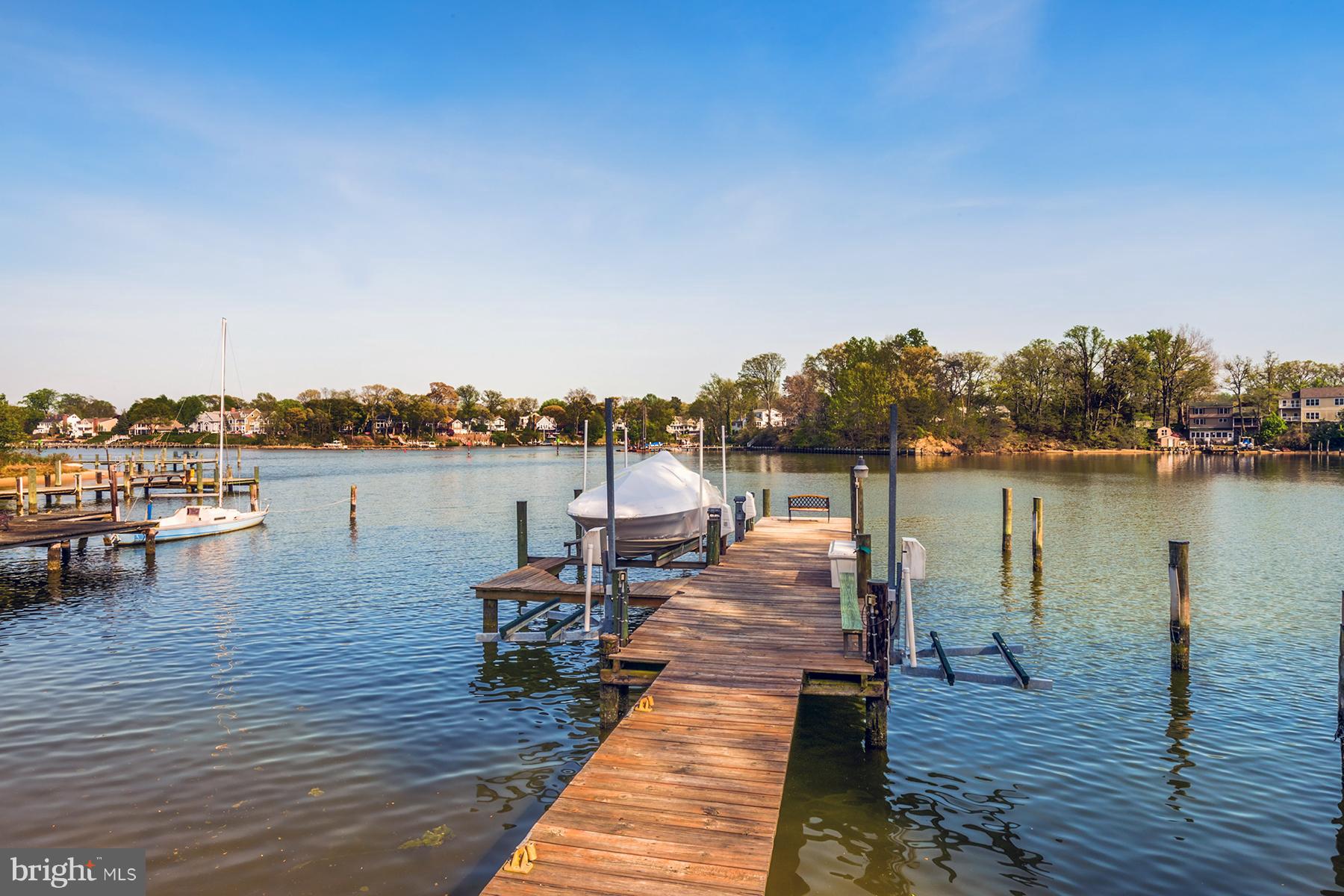 503 Broadwater Road Arnold, MD 21012 - Photo 2 of 30 a lake view with a table and chairs on wooden floor