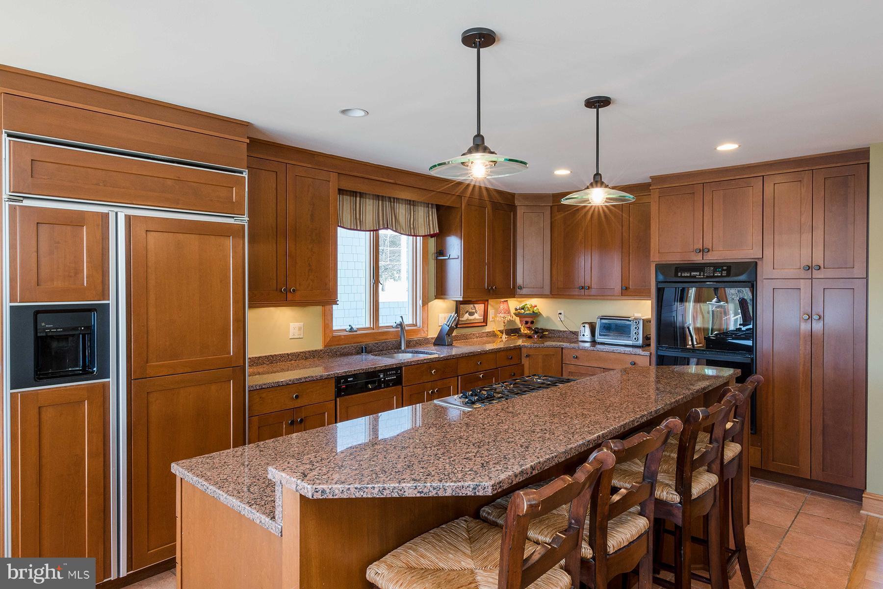 503 Broadwater Road Arnold, MD 21012 - Photo 7 of 30 a kitchen with granite countertop a table chairs microwave and refrigerator